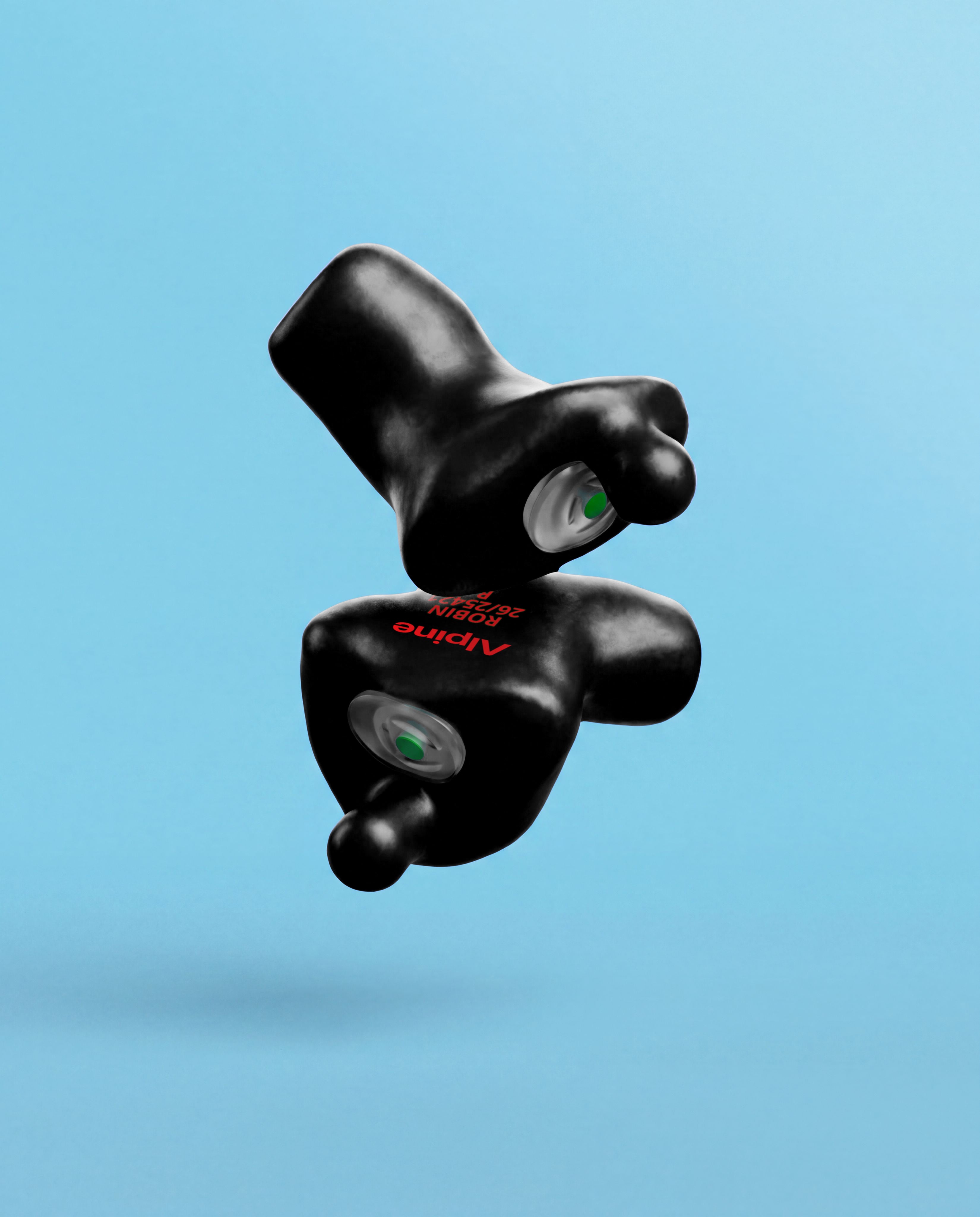 Pair of Alpine Xtreme Custom Black earplugs with green filters, floating against a light blue background