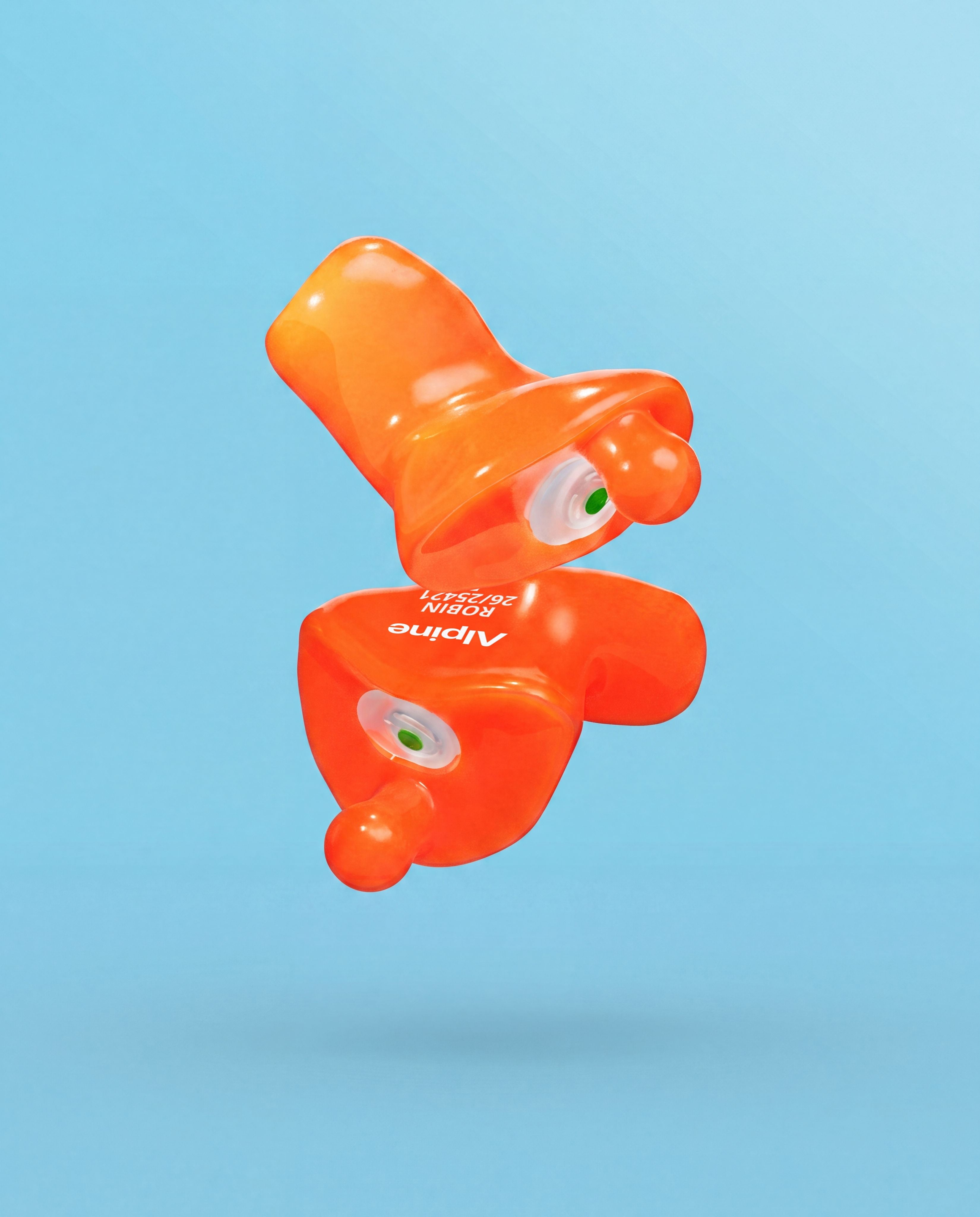 Pair of Alpine Xtreme Custom Orange earplugs with green filters, floating against a light blue background