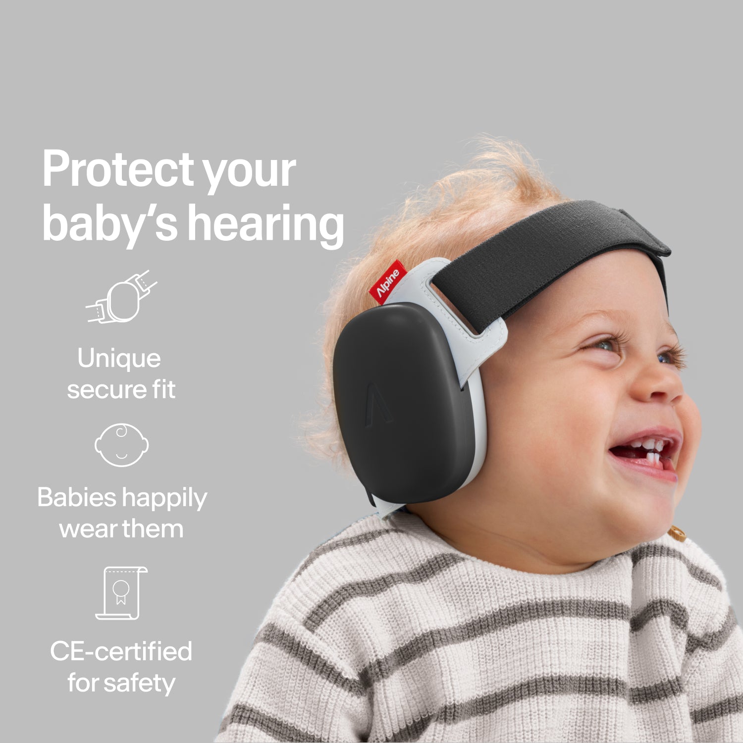 Happy baby wearing black Alpine ear muffs with secure fit, CE-certified hearing protection