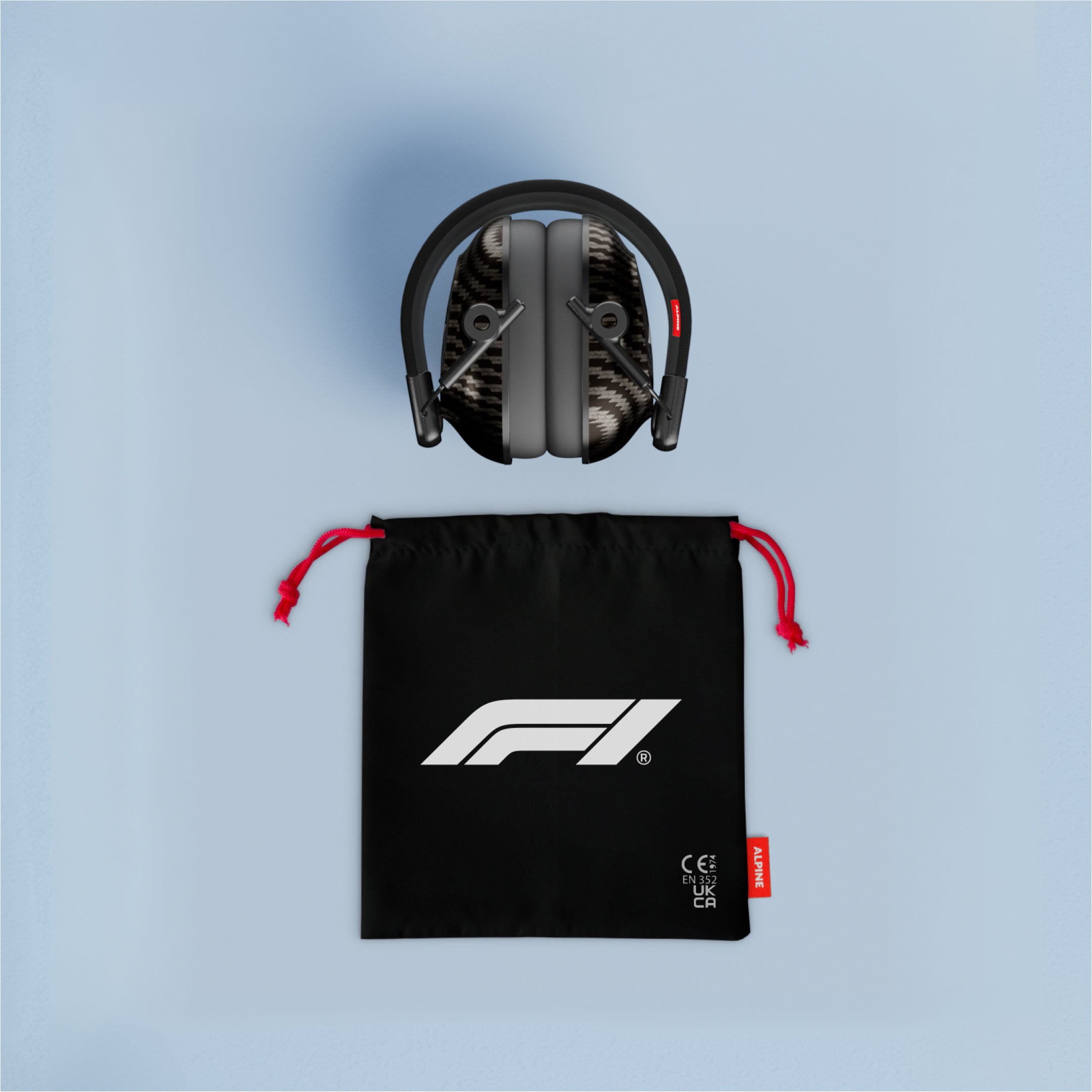 Folded Alpine Formula 1 Earmuffs above a black drawstring pouch with red cords and F1 logo