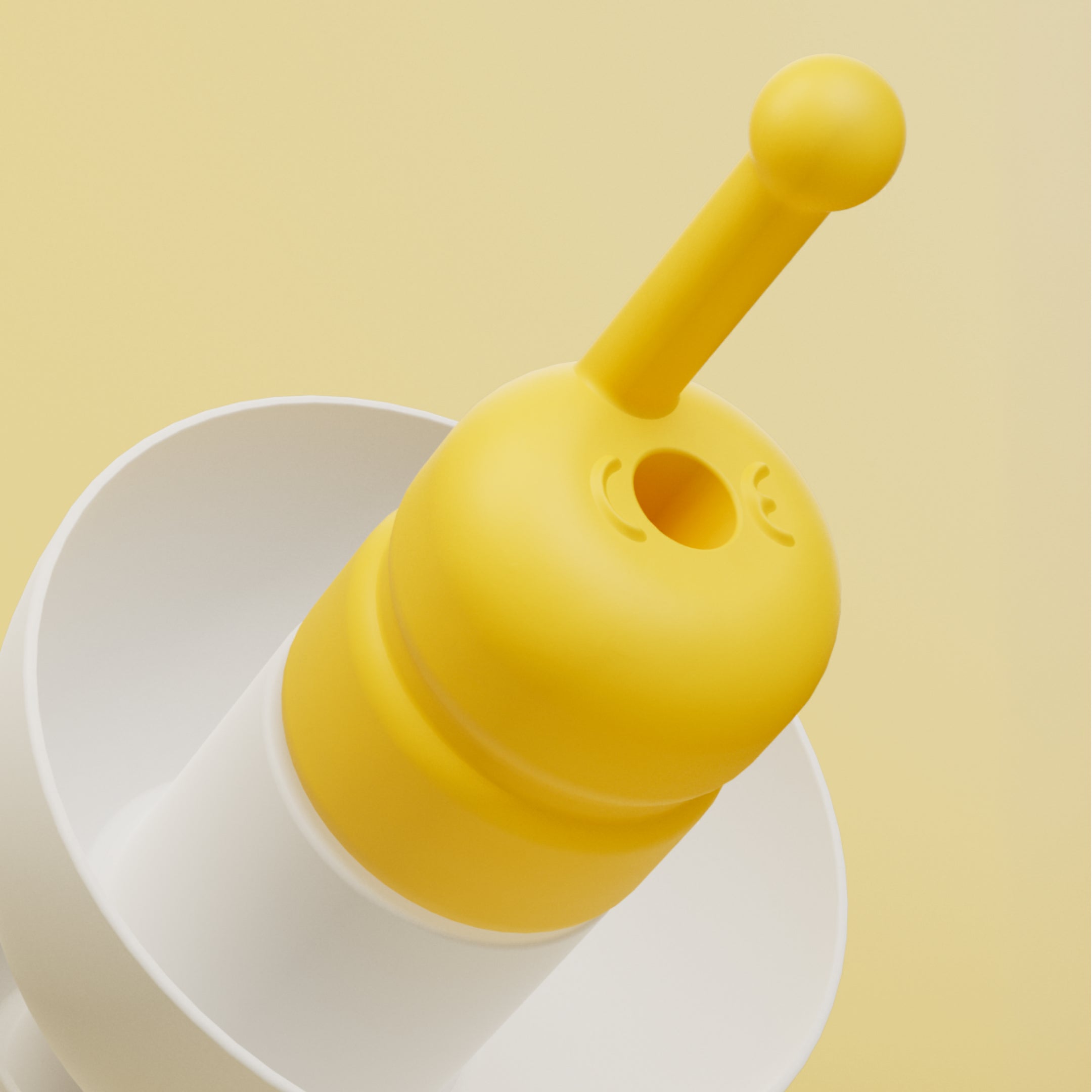Alpine FlyFit close-up of the yellow filter with central opening and pull stem on a white earplug 